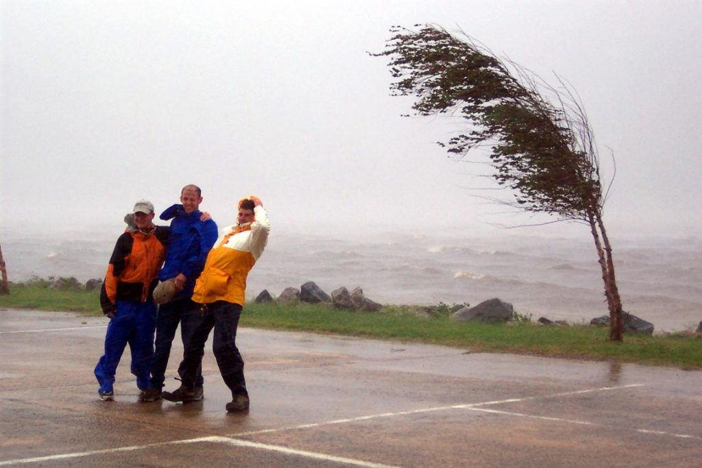The team standing in the parking lot blown over by the winds