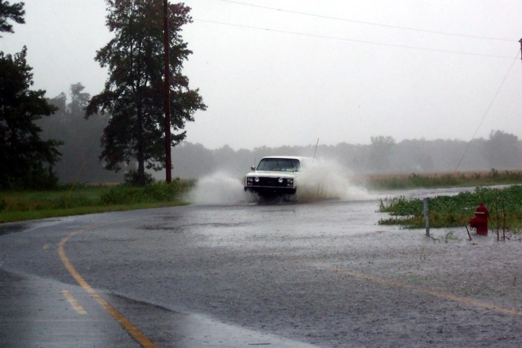 The truck driving around a flooded corner